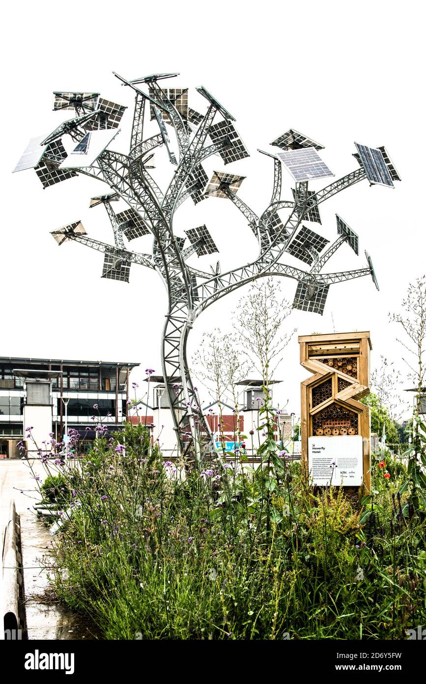 Energy Tree, Millennium Square Bristol England. This sculpture charges your phone for free. Also pictured, Hoverfly Hotel, wood pollinator insect home. Stock Photo