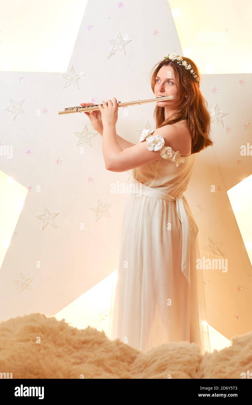 Young woman musician plays flute hires stock photography and images
