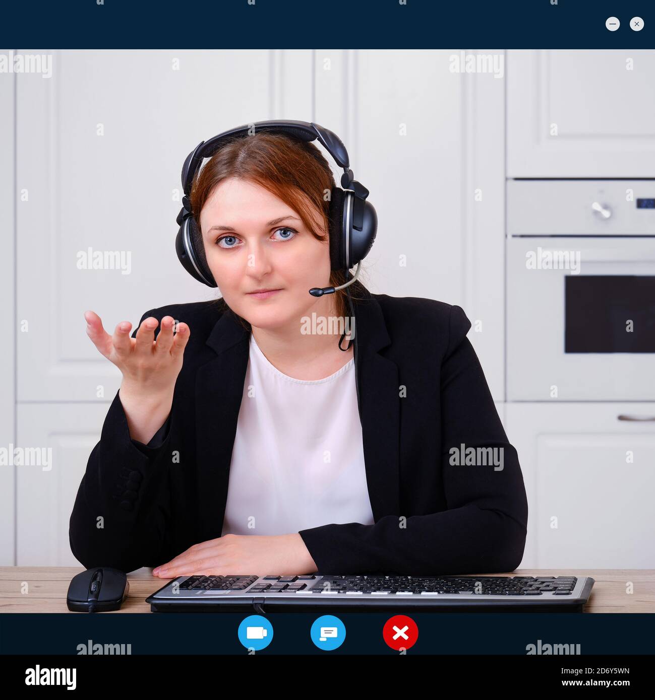 A woman asks a question during an online conference at a remote job from home. Businesswoman talks in a video call in an Internet chat, the program in Stock Photo