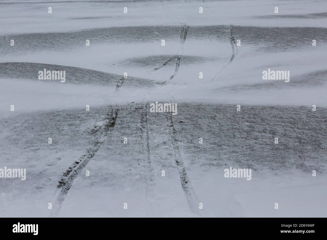 Tyre tracks across a snowy landscape Stock Photo