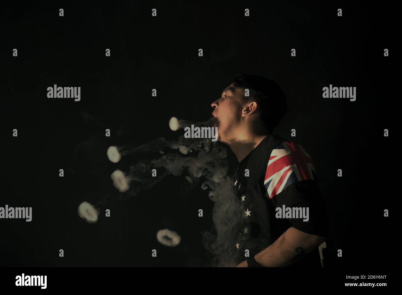 A vape cloud performer demonstrating some of his tricks inside a vape cafe in Banten province, Indonesia. Stock Photo