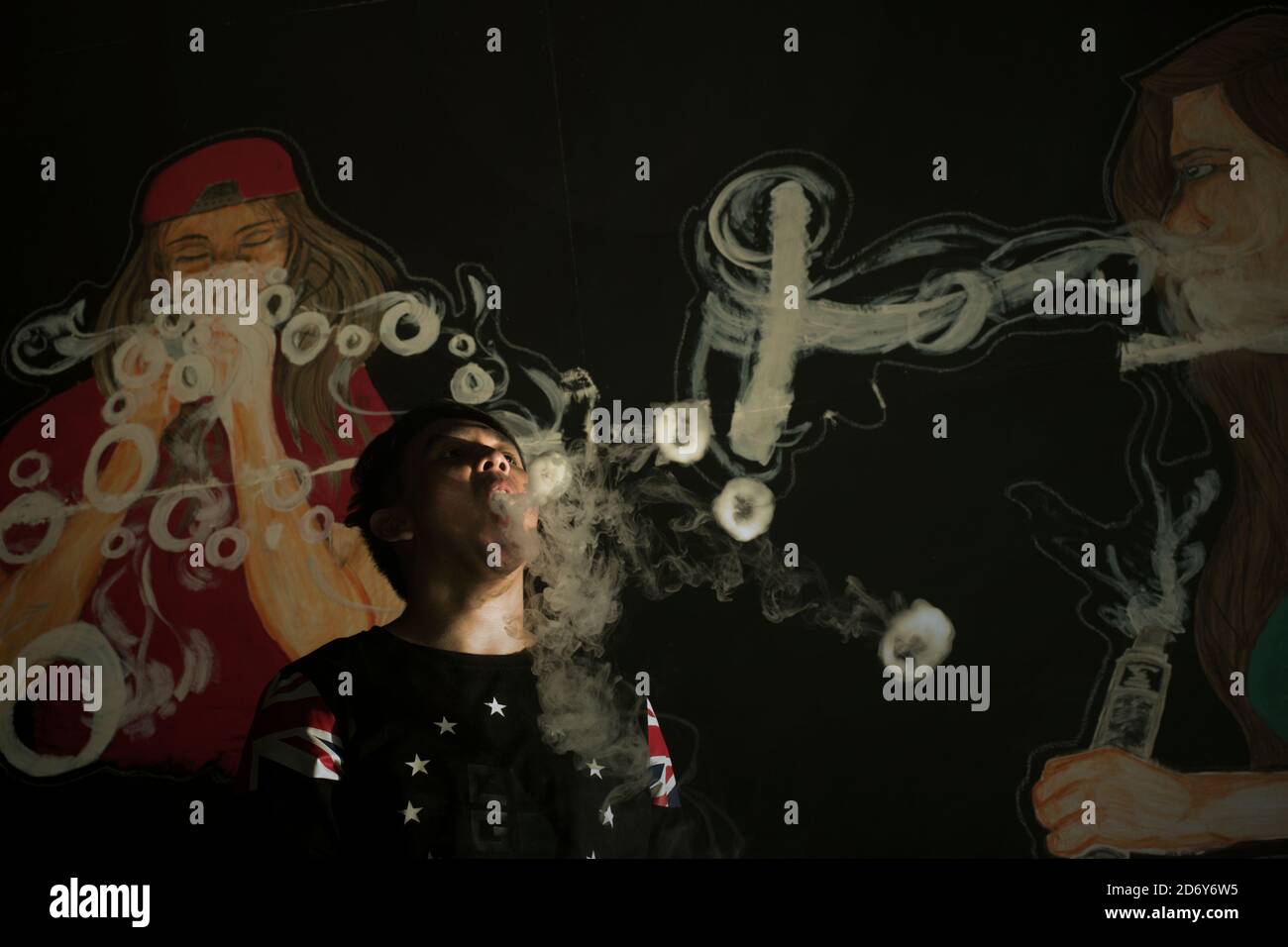 A vape cloud performer demonstrating some of his tricks inside a vape cafe in Banten province, Indonesia. Stock Photo