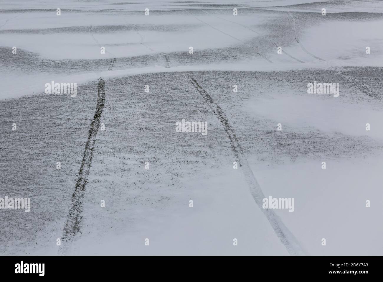 Tyre tracks across a snowy landscape Stock Photo