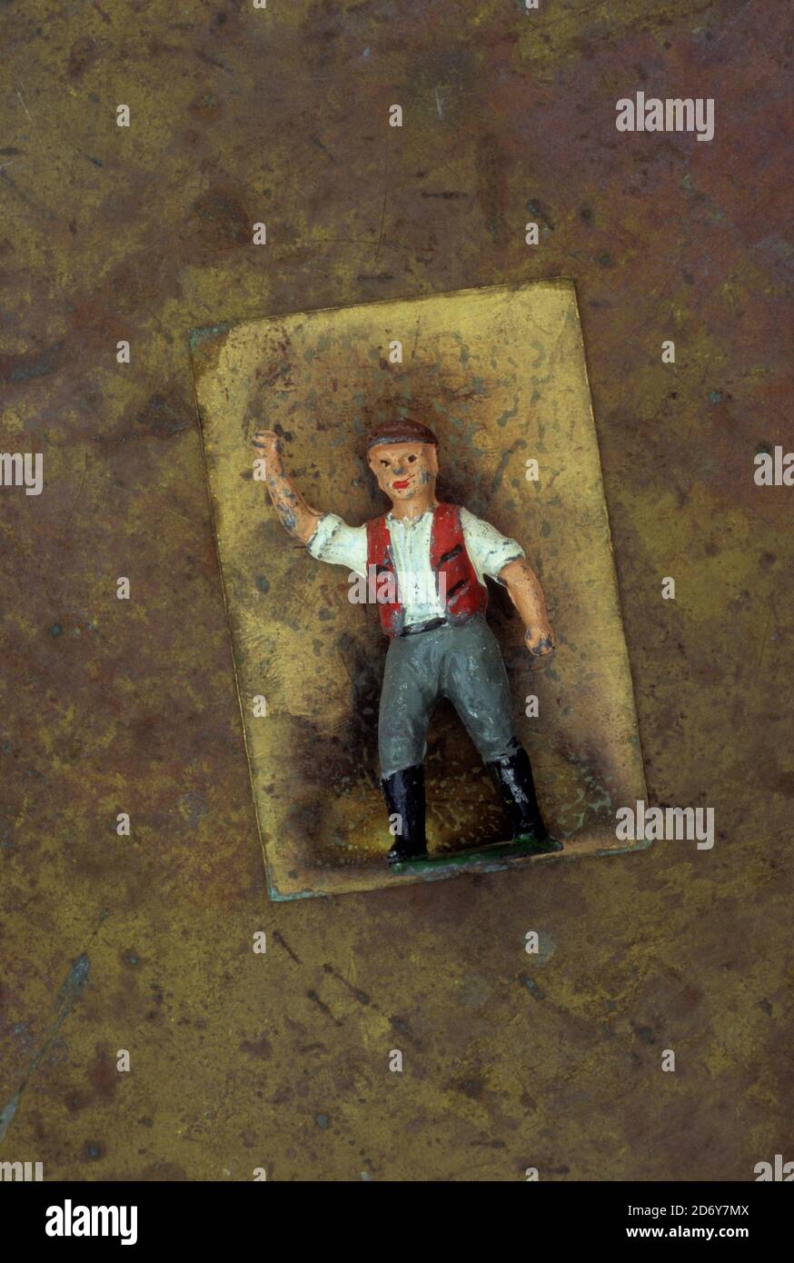 Vintage lad model of workman or labourer in cap and waistcoat shaking his fist Stock Photo