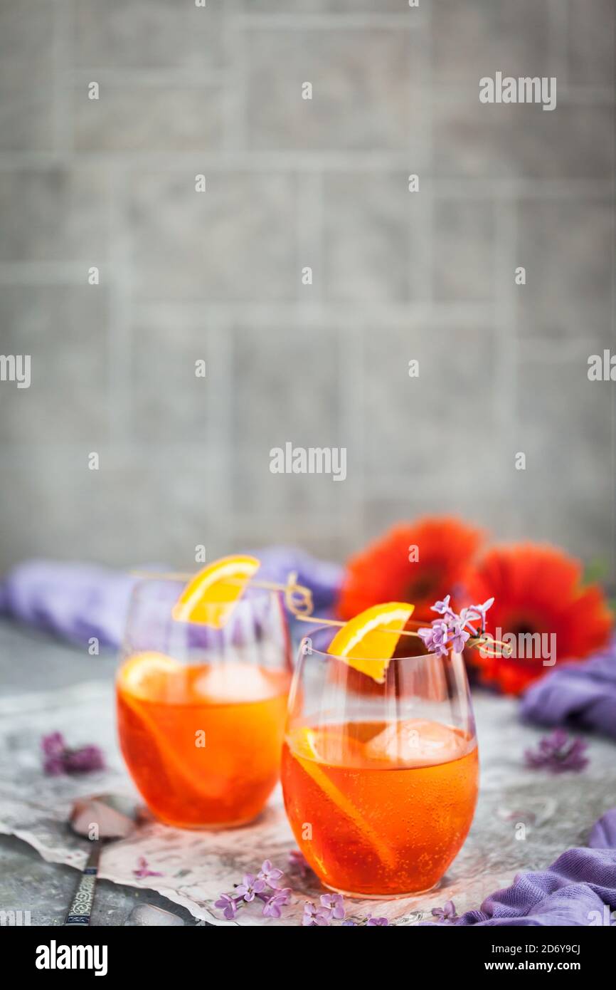 Orange Aperol Spritz cocktail served in a wine glasses, decorated with ...