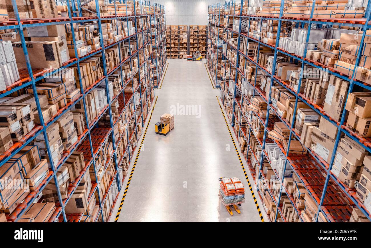 interior of a large warehouse with very high shelves and lifting