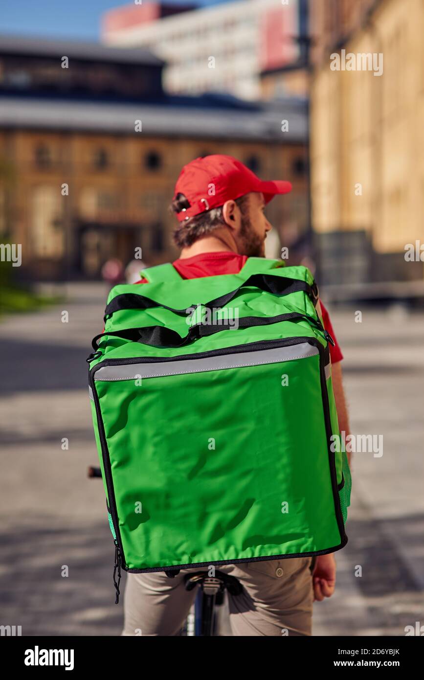 Large refrigerator bag on courier's back during working day on delivery