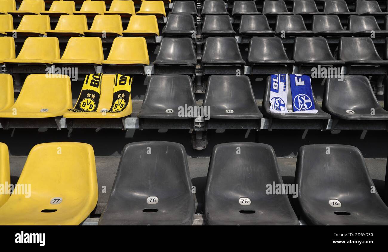 Dortmund, Deutschland. 08th May, 2020. firo: 08.05.2020, football, 1st Bundesliga, 2019/2020 season, BVB, Borussia Dortmund, SIGNAL IDUNA PARK stadium, before DERBY, Revierderby BVB - Schalke 04, restart of the Bundesliga after interruption by CORONA, COVID-19, scarves of the two clubs BVB and Schalke on the empty seat shells, with distance, seats, empty range, ghost game, no spectators, | usage worldwide Credit: dpa/Alamy Live News Stock Photo