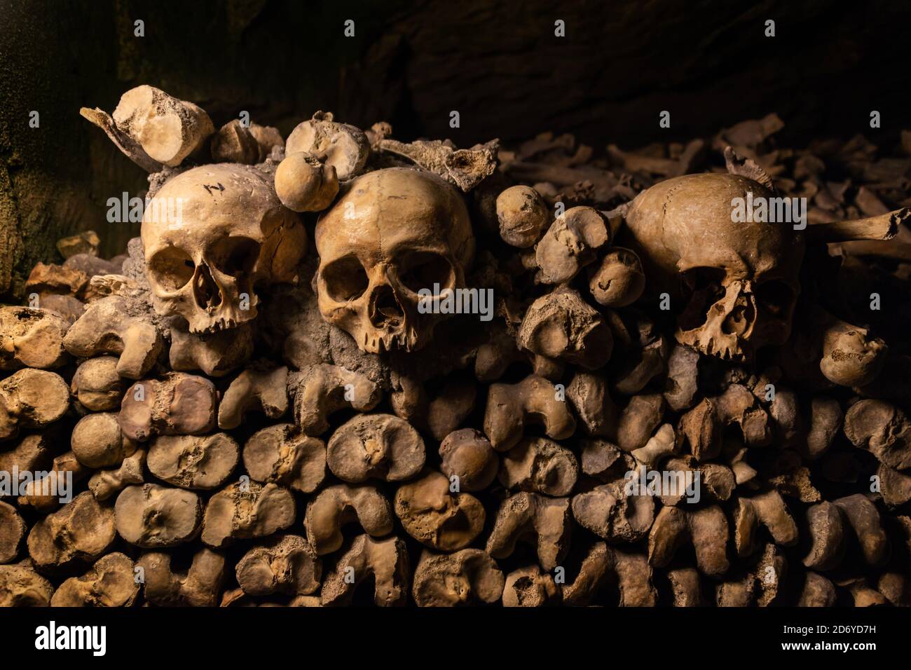 Stack of skulls and bones in the catacombs of Paris, France Stock Photo