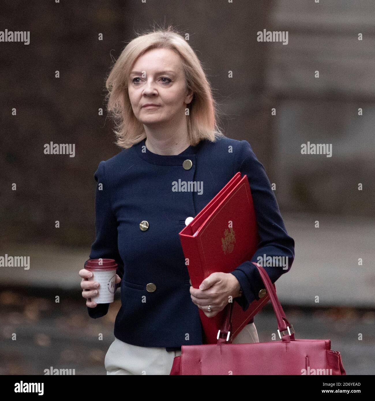 Liz Truss walks up Downing Street to a cabinet meeting on the 20th of October 2020, wearing a navy blue jacket and holding the ministers, red folder. Stock Photo