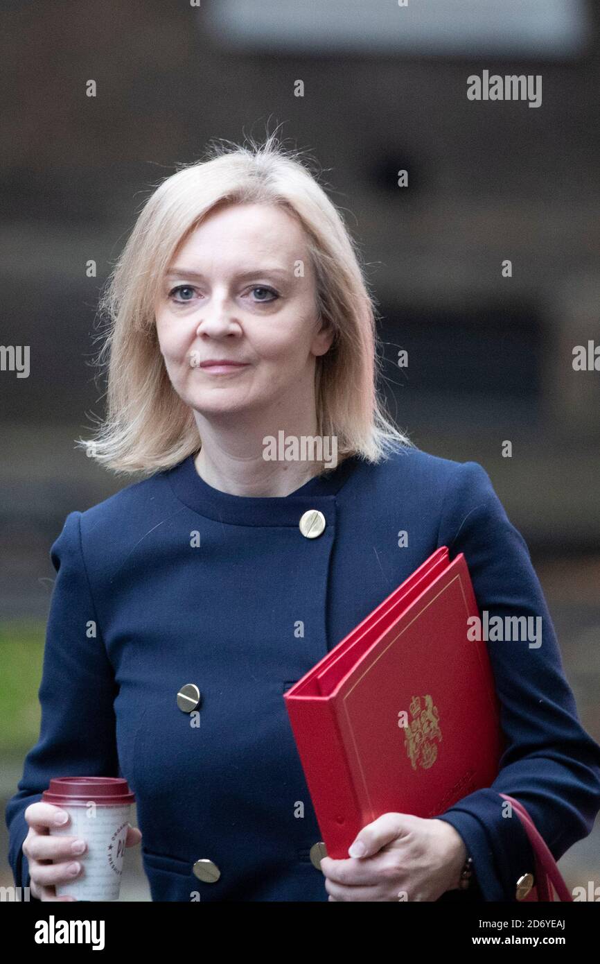 Liz Truss walks up Downing Street to a cabinet meeting on the 20th of October 2020, wearing a navy blue jacket and holding the ministers, red folder. Stock Photo