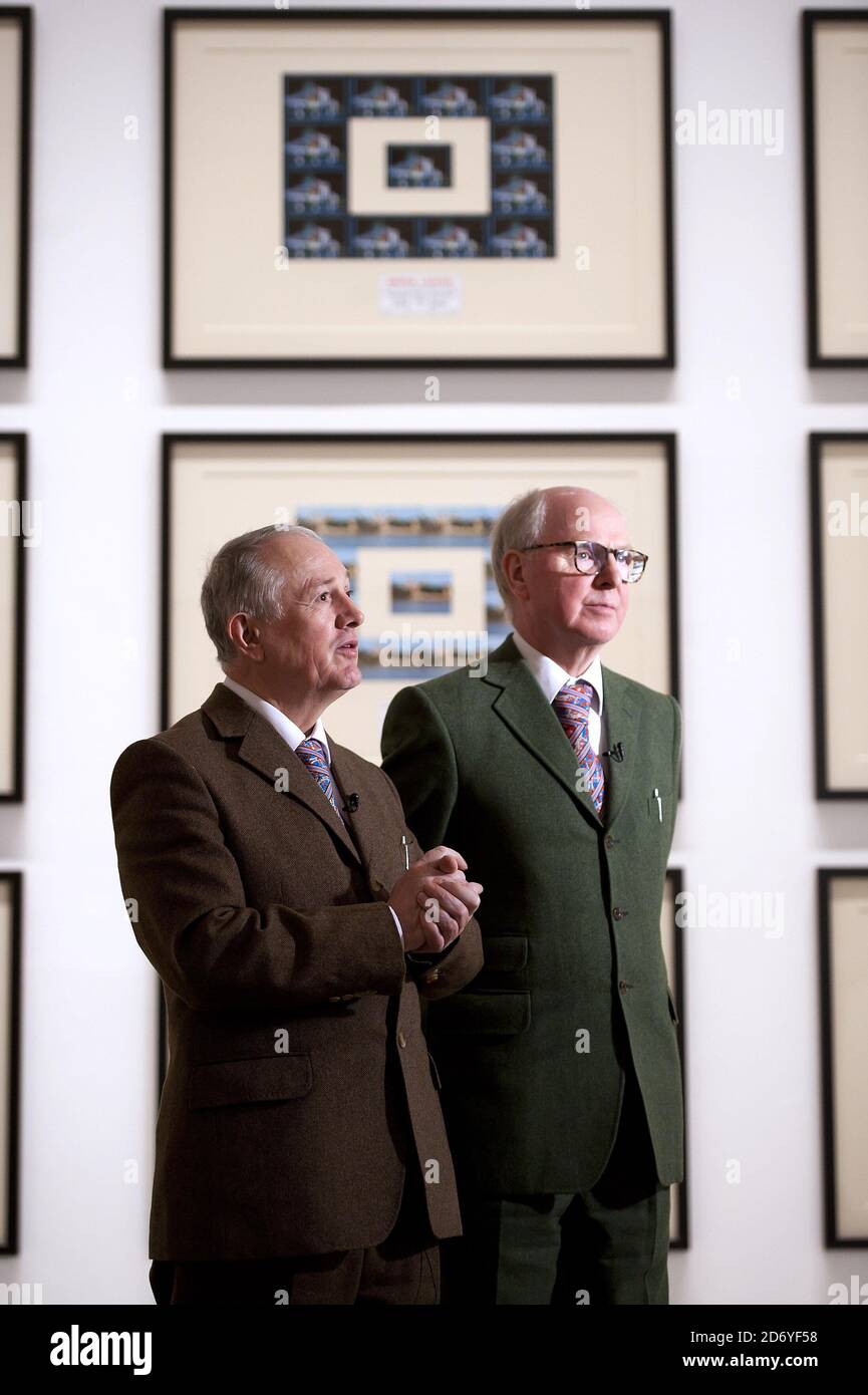 Artists Gilbert Proesch (l) and George Passmore (r) pictured at the press view of their latest exhibition, The Urethra Postcard Art of Gilbert and George, at the White Cube gallery in central London.  Stock Photo