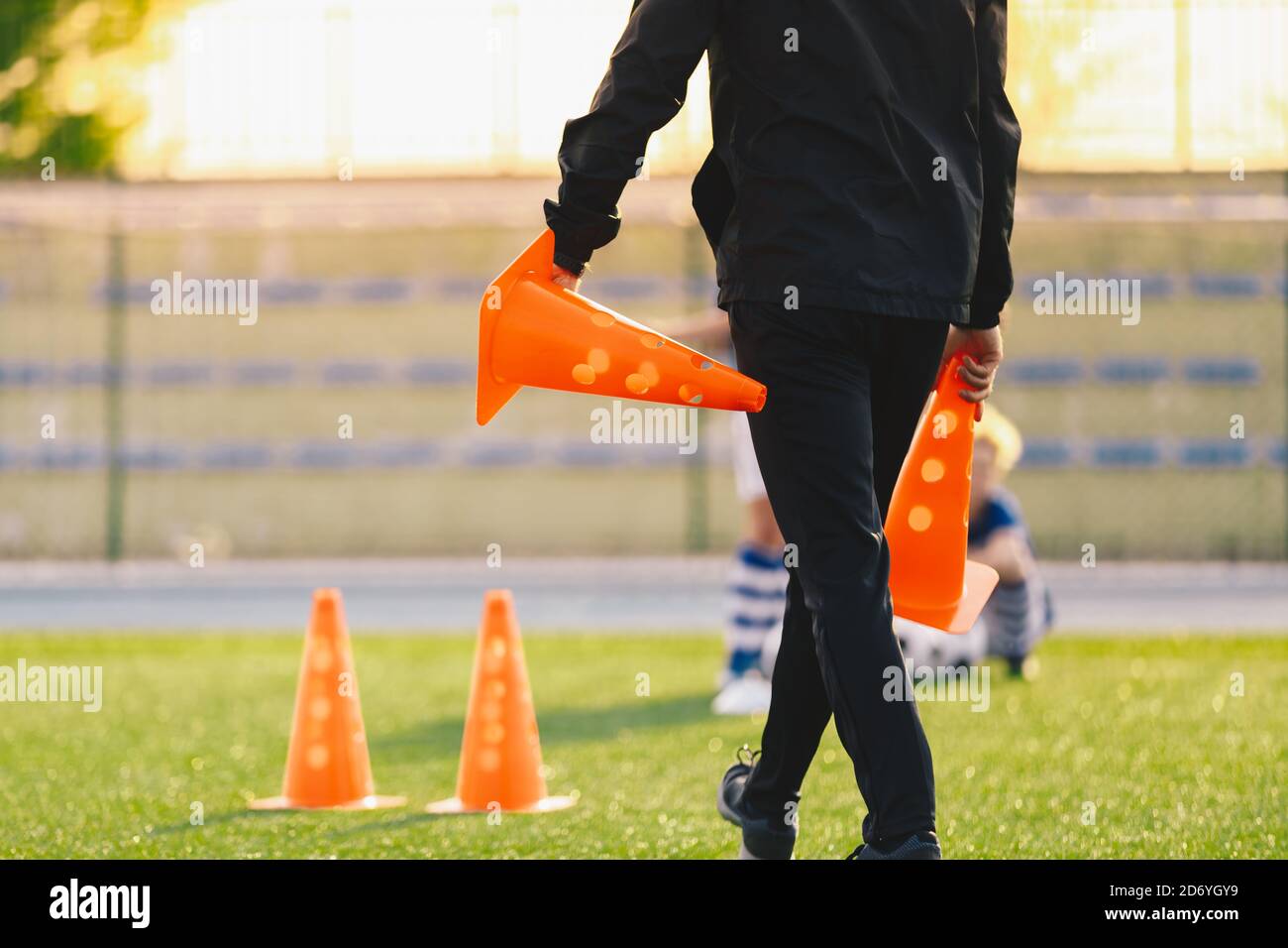 Soccer Coach Preparing Training Field. Trainer Holding Soccer Practice Cones. Coaching Youth
