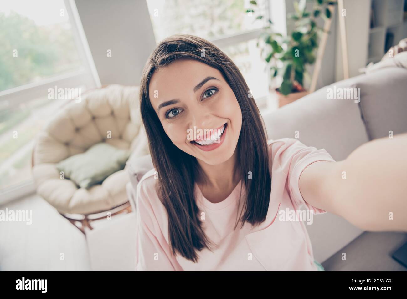 Photo portrait of cute girl taking selfie smiling sincerely sitting on ...