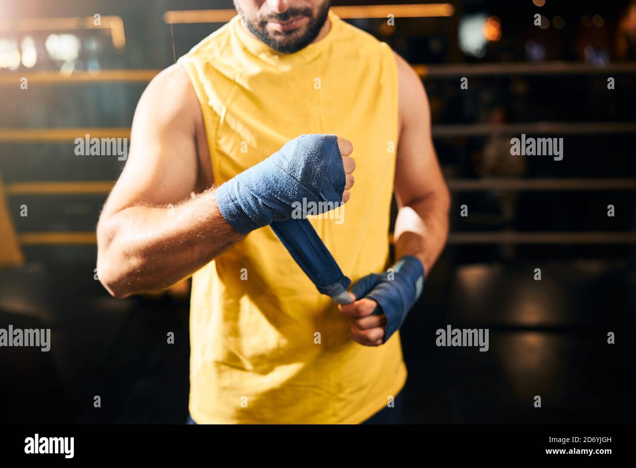 Athletic man wrapping his arm into boxing wraps Stock Photo Alamy
