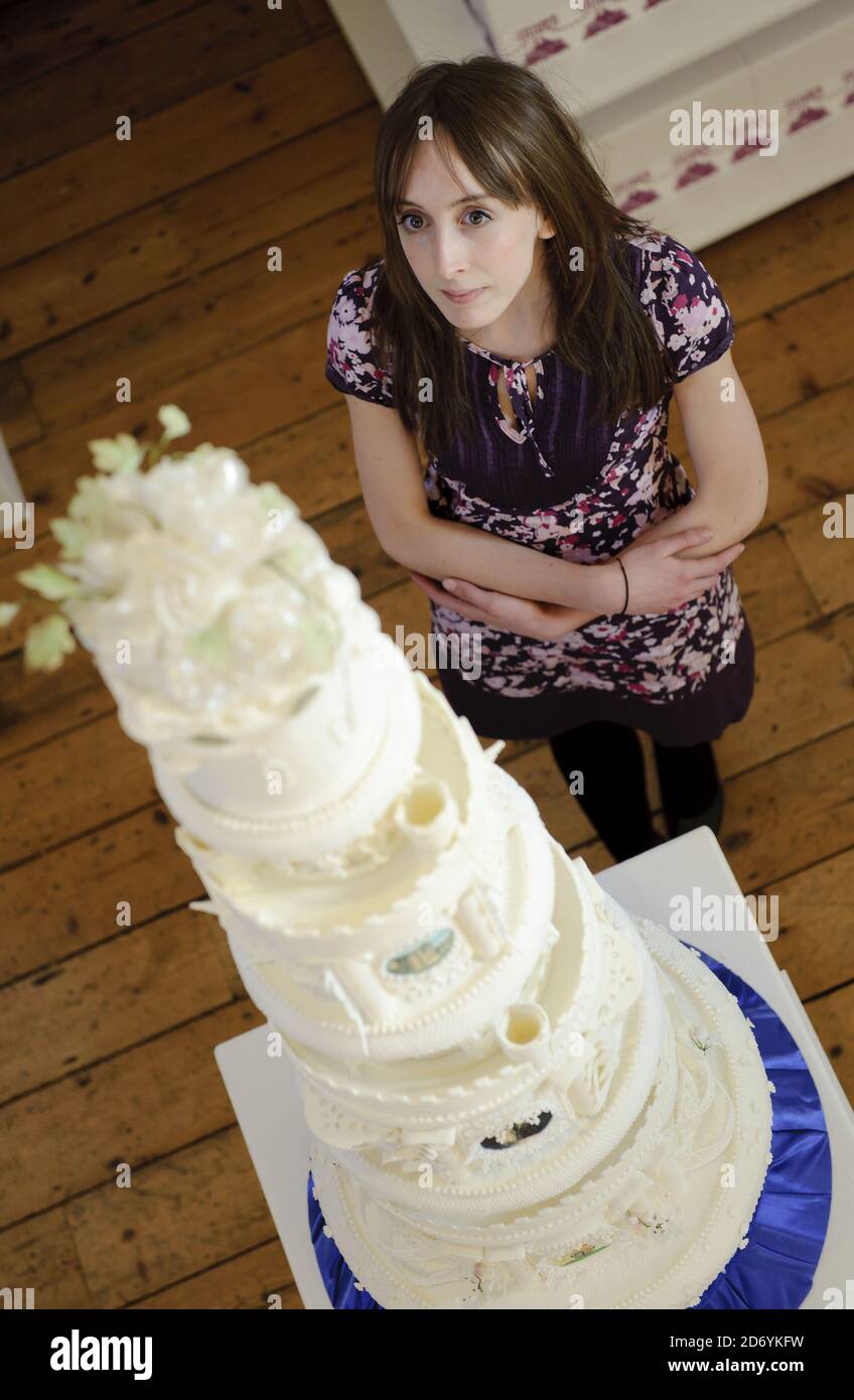 A visitor admires a replica of King George VI and the Queen Mothers' wedding cake, at the Tate and Lyle 'Let Them Eat Cake' exhibition of royal themed cakes, at the Wellington Arch in central London. Stock Photo