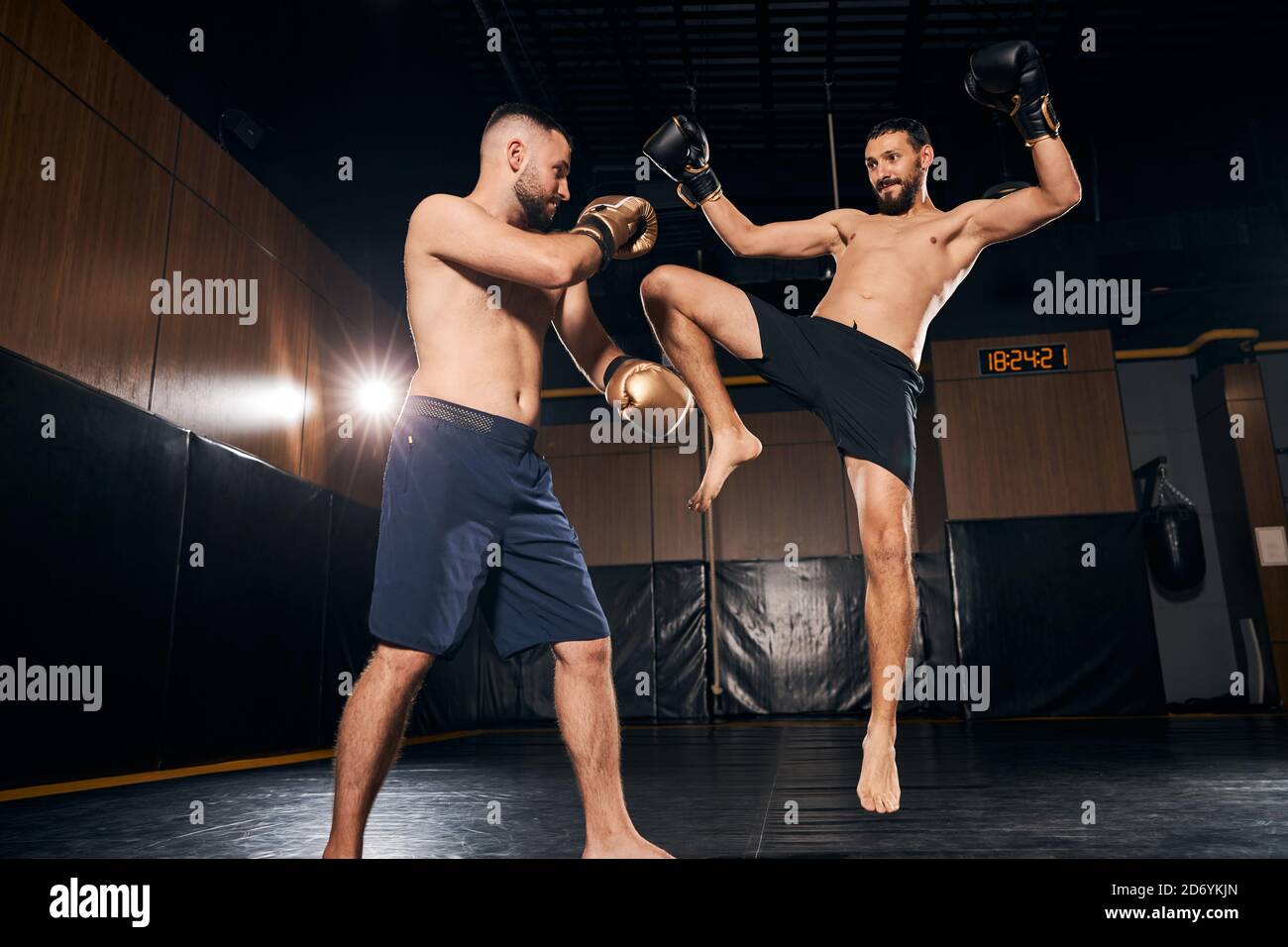 Boxer jumping and hitting the opponent with his leg Stock Photo Alamy