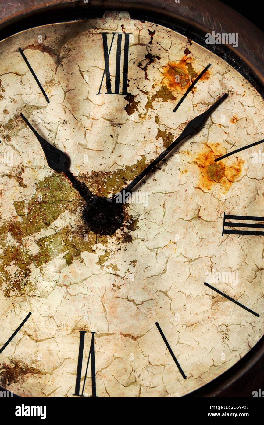 Distressed old clock face with Roman numerals. Stock Photo
