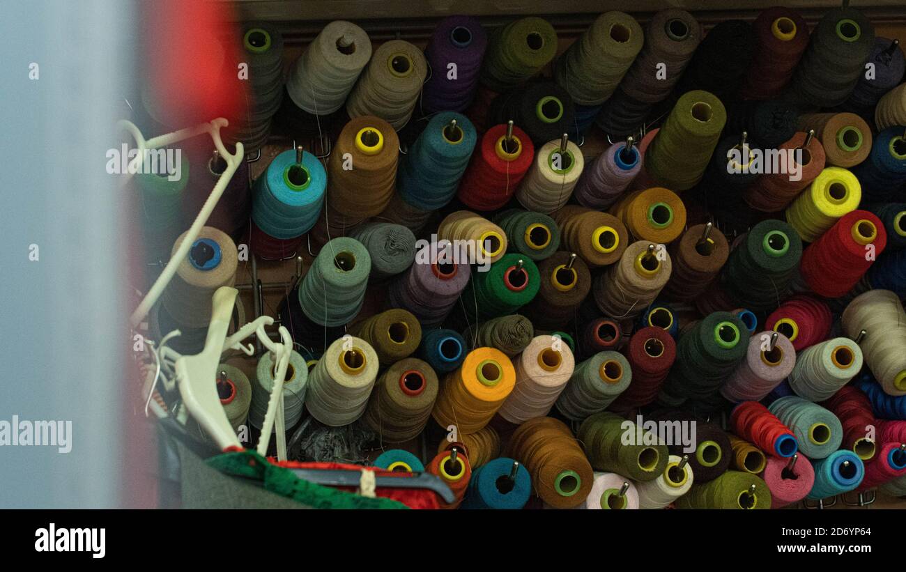 rolls of fabric stacked on a shelf Stock Photo