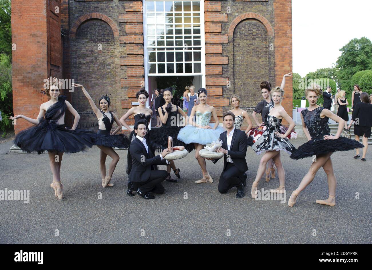 Ballet dancers wear dresses to be auctioned at the English National Ballet summer party, at the Orangery in Kensington Gardens, central London. Stock Photo