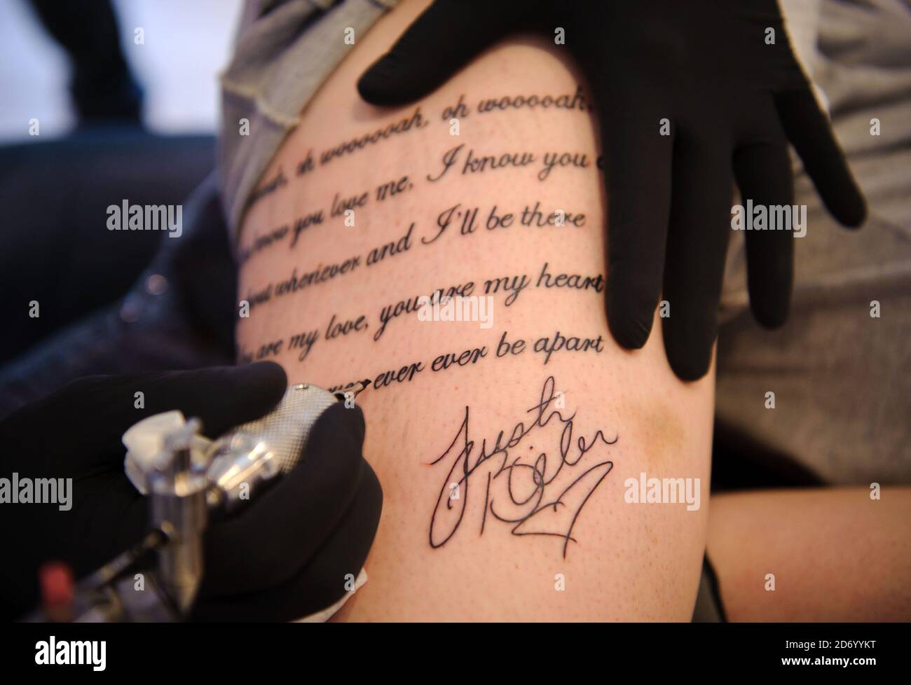 MTV competition finalist Sarah Burgoyne (24) shows what she is willing to  do for music by tattooing Justin Bieber lyrics on her thigh, at the Good  Time tattoo studio in east London.