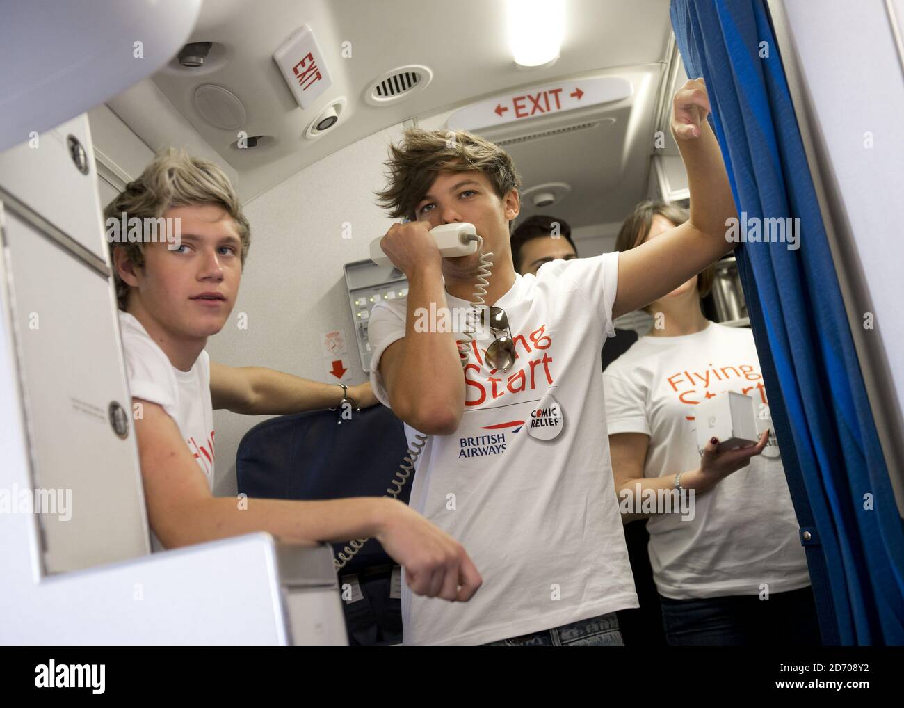 Niall Horan And Louis Tomlinson Of One Direction Conduct A Quiz For Passengers On Board Flight Ba1d A Private Charter Flight From London To Manchester Hosted By The Band For Competition