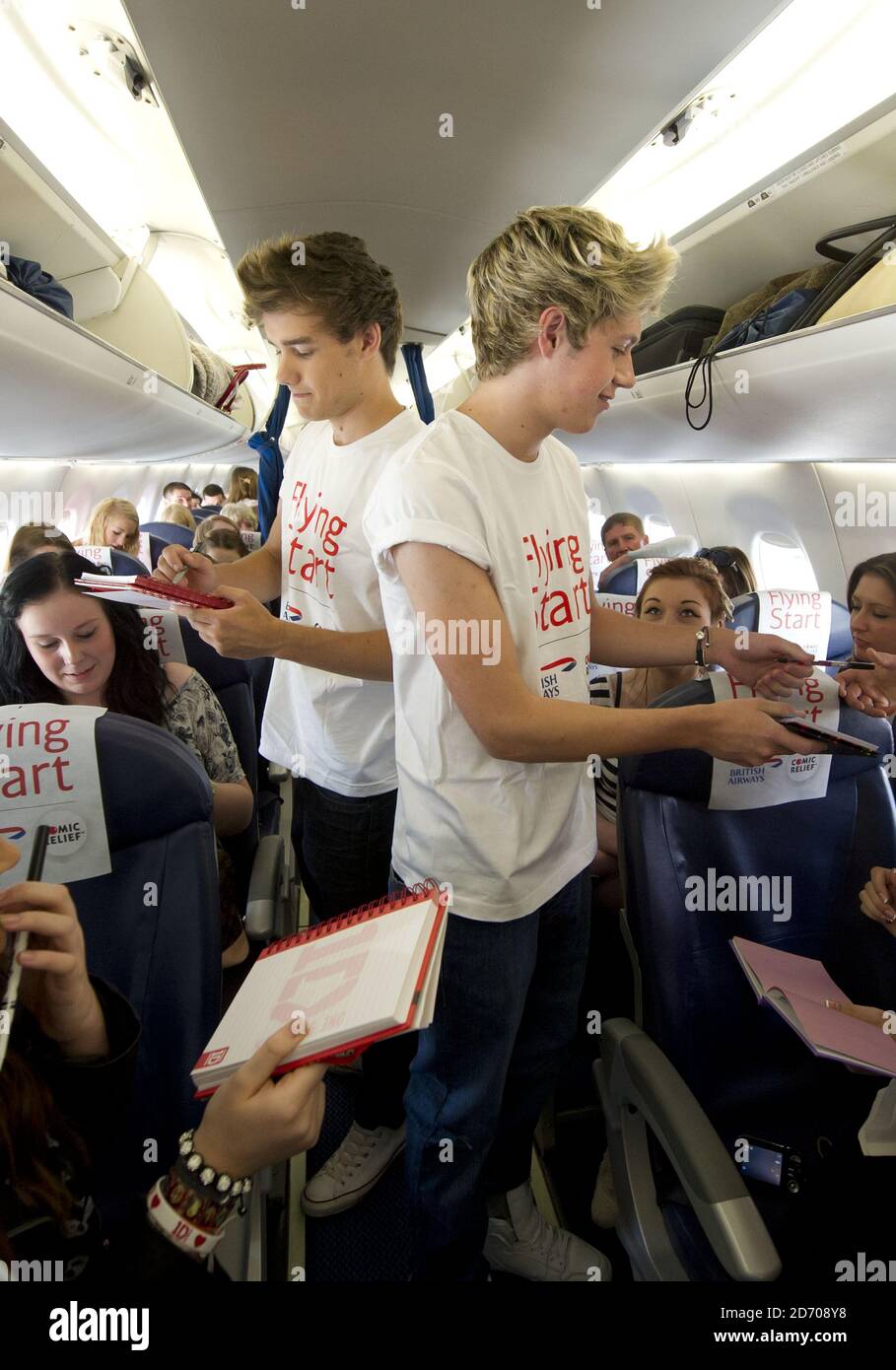 Liam Payne And Niall Horan Of One Direction Pictured On Board Flight Ba1d A Private Charter Flight From London To Manchester Hosted By The Band For Competition Winners Which Raised A 50 000
