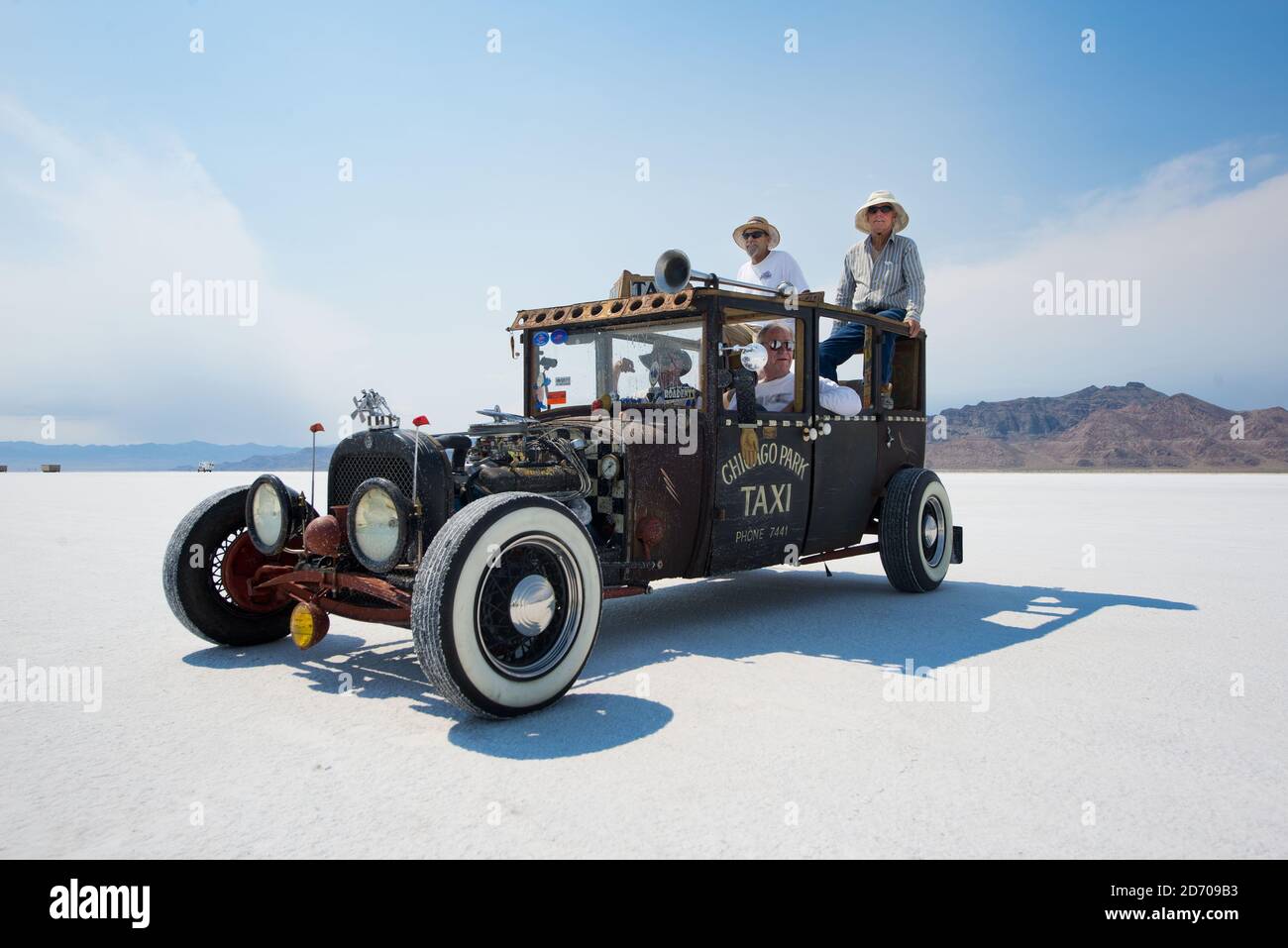 Spectators watch the action during Bonneville Speed Week, held on the Bonneville Salt Flats in Utah, USA. The annual event sees hundreds of car builders and drivers gather on the salt flats to try and break land speed records in various different categories of vehicle. Stock Photo