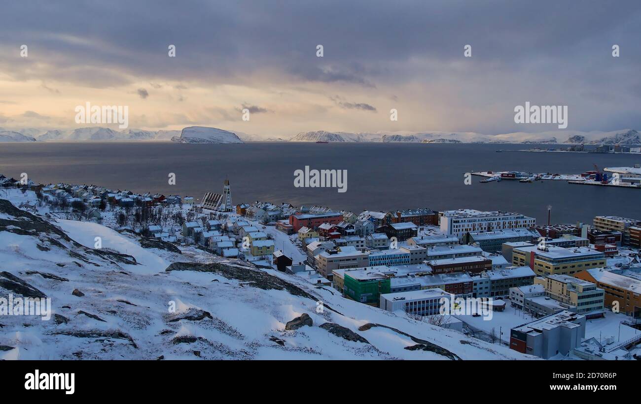 Hammerfest, Norway - 03/01/2019: Aerial view of the center of Hammerfest located on the coast of the arctic sea with snow-covered mountains. Stock Photo