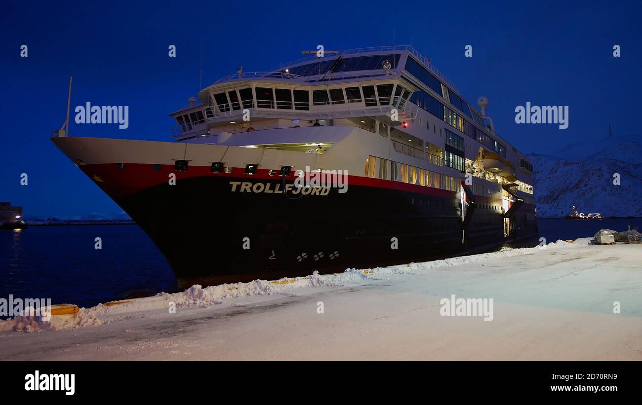 Honningsvåg, Norway - 03/02/2019: Hurtigruten cruise ship (RoRo ferry) MS Trollfjord arriving at pier in the harbor of Honningsvåg in early morning. Stock Photo