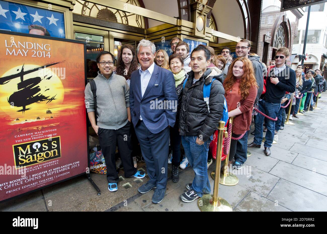 Producer Cameron Mackintosh welcomes theatre-goers queuing for Miss Saigon tickets, at the Prince Edward theatre in central London. Tickets for the show (opening May 2014) went on sale at 10am today, and sales set a new record for the largest single day of sales in West End and Broadway history. Stock Photo