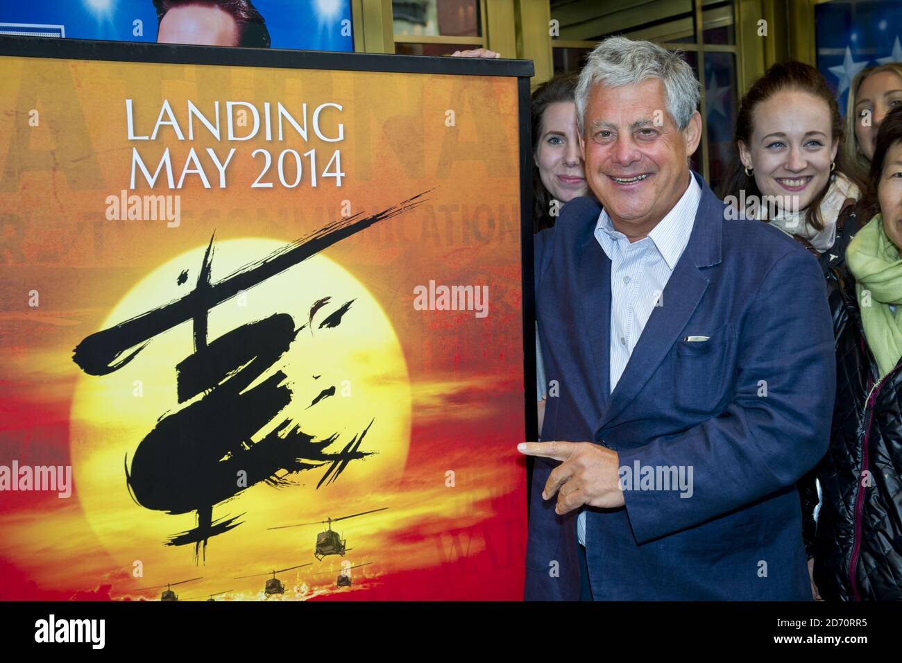 Producer Cameron Mackintosh welcomes theatre-goers queuing for Miss Saigon tickets, at the Prince Edward theatre in central London. Tickets for the show (opening May 2014) went on sale at 10am today, and sales set a new record for the largest single day of sales in West End and Broadway history. Stock Photo