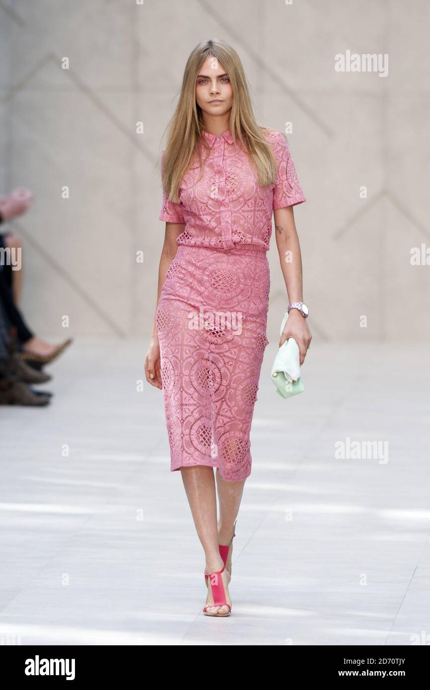 Model Cara Delevingne on the catwalk at the Burberry fashion show, held in Hyde Park as part of London Fashion Week spring/summer 2014. Stock Photo