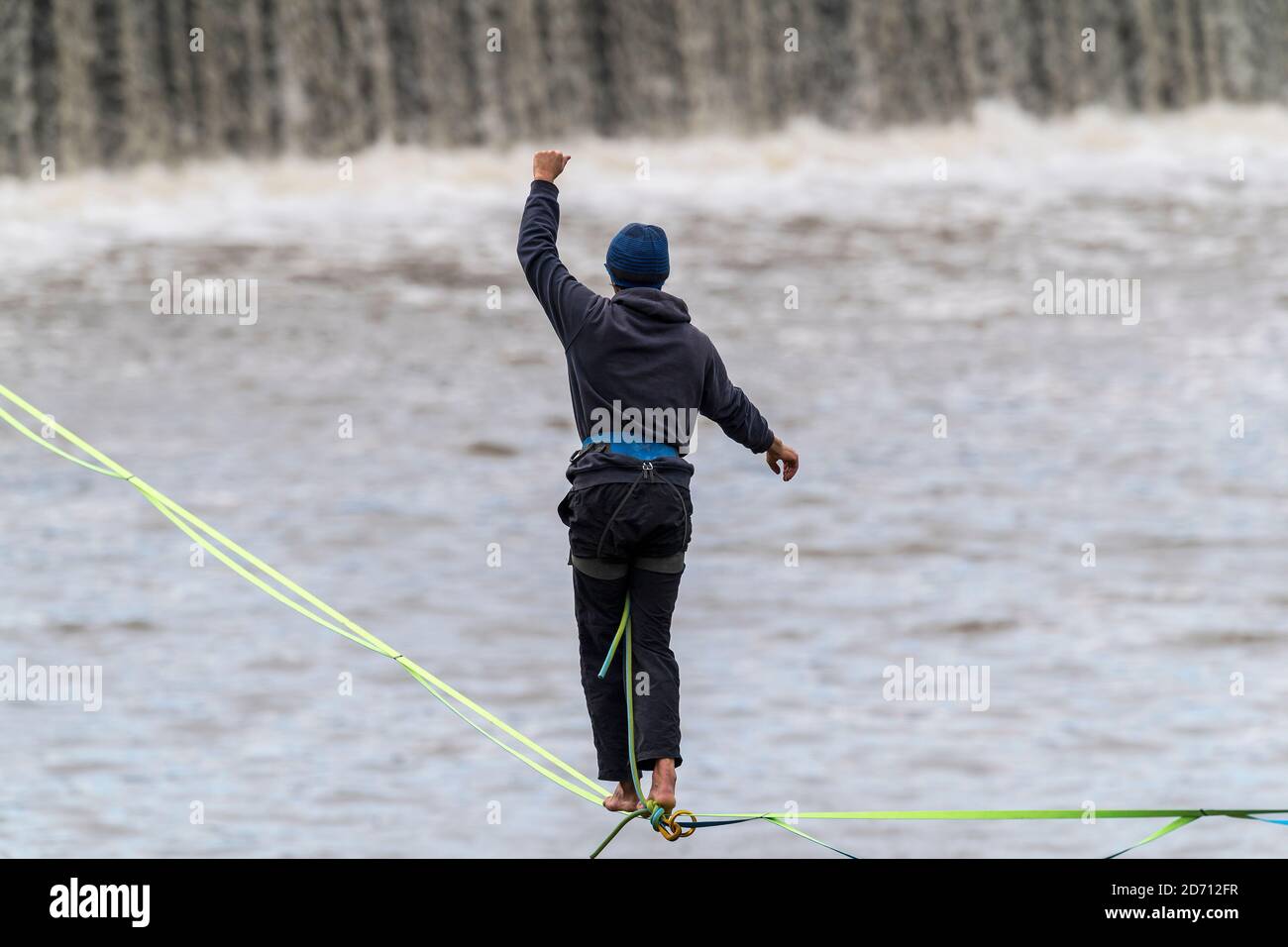 a tightrope walker on slack line above the Vltava river with background of panorama of Prague Castle, Czech republic Stock Photo
