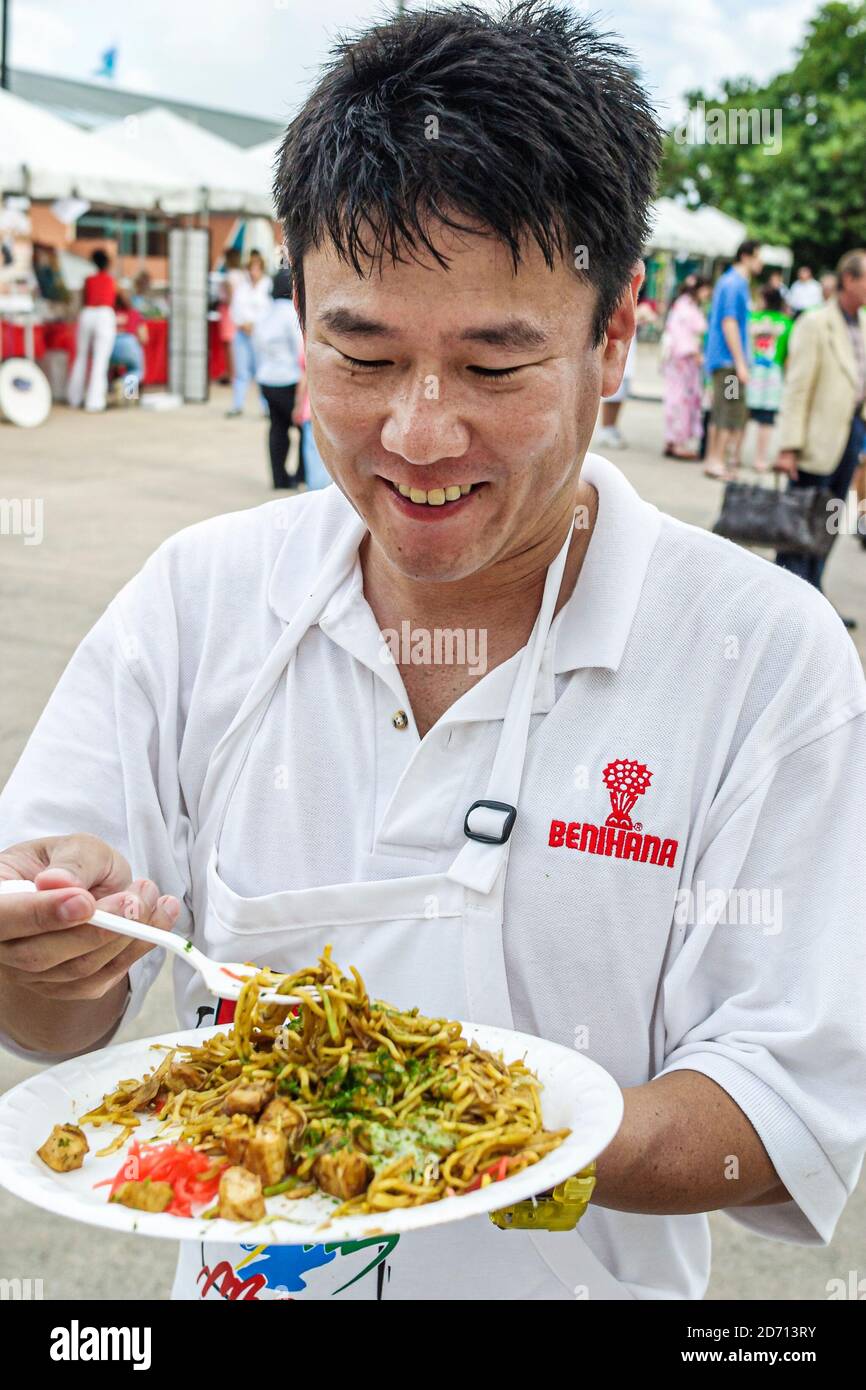 Miami Florida,Bayfront Park Japanese Festival annual Asian man male eating chow mein Benihana cook chef, Stock Photo
