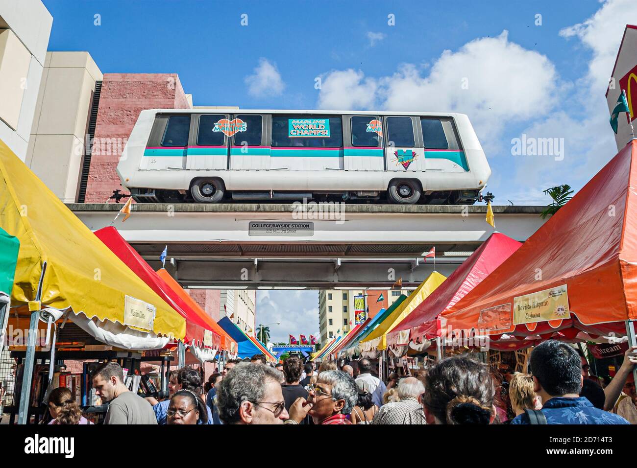 Miami Florida,International Book Fair festival,annual event vendors sellers stalls booths tents crowd people,colorful Metromover free shuttle rail Stock Photo