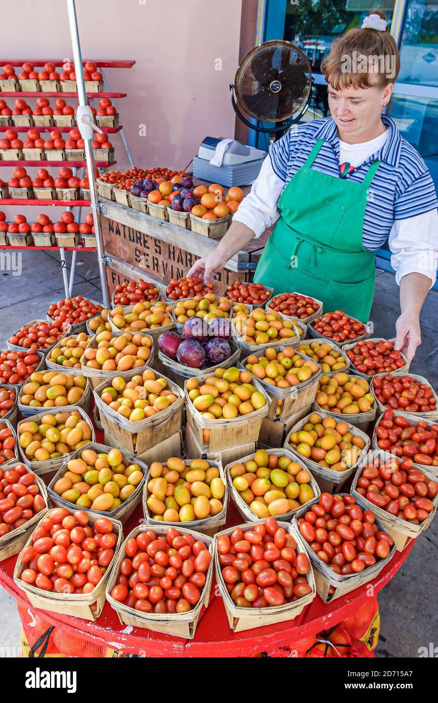 Florida Turnpike Fort Drum Rest Stop,local produce display sale small cherry tomatoes baskets,woman female selling, Stock Photo