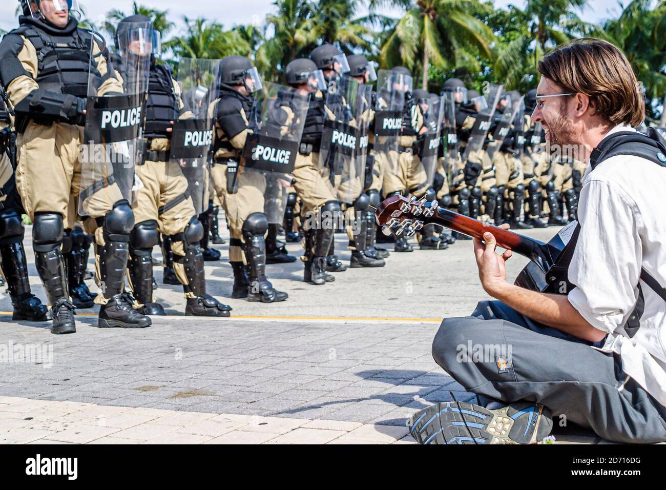 Miami Florida,Biscayne Boulevard,Free Trade Area of Americans Summit FTAA demonstrations,protester male student sitting police line riot gear shields Stock Photo