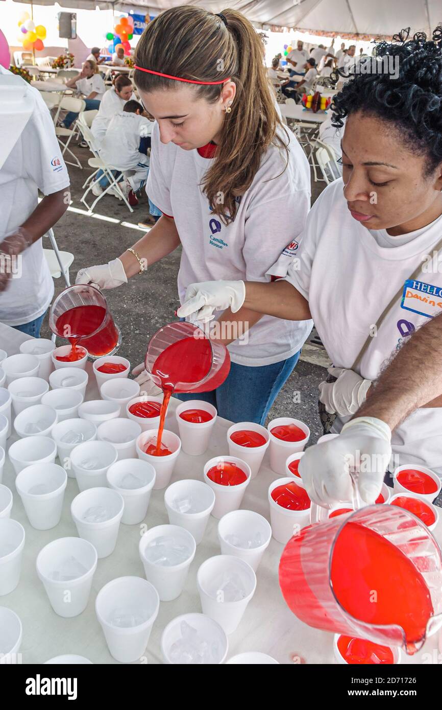 Miami Florida,Camillus House annual Thanksgiving lunch poor homeless shelter,volunteers Black African Hispanic woman female women helping prepare prep Stock Photo