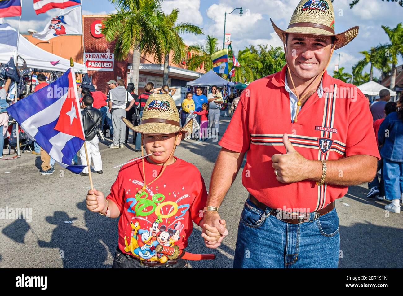 Miami Florida,Little Havana,Hispanic Calle Ocho,Tres Reyes Magos Three 3 Kings parade,family father son man boy Cuban flag waving waves, Stock Photo