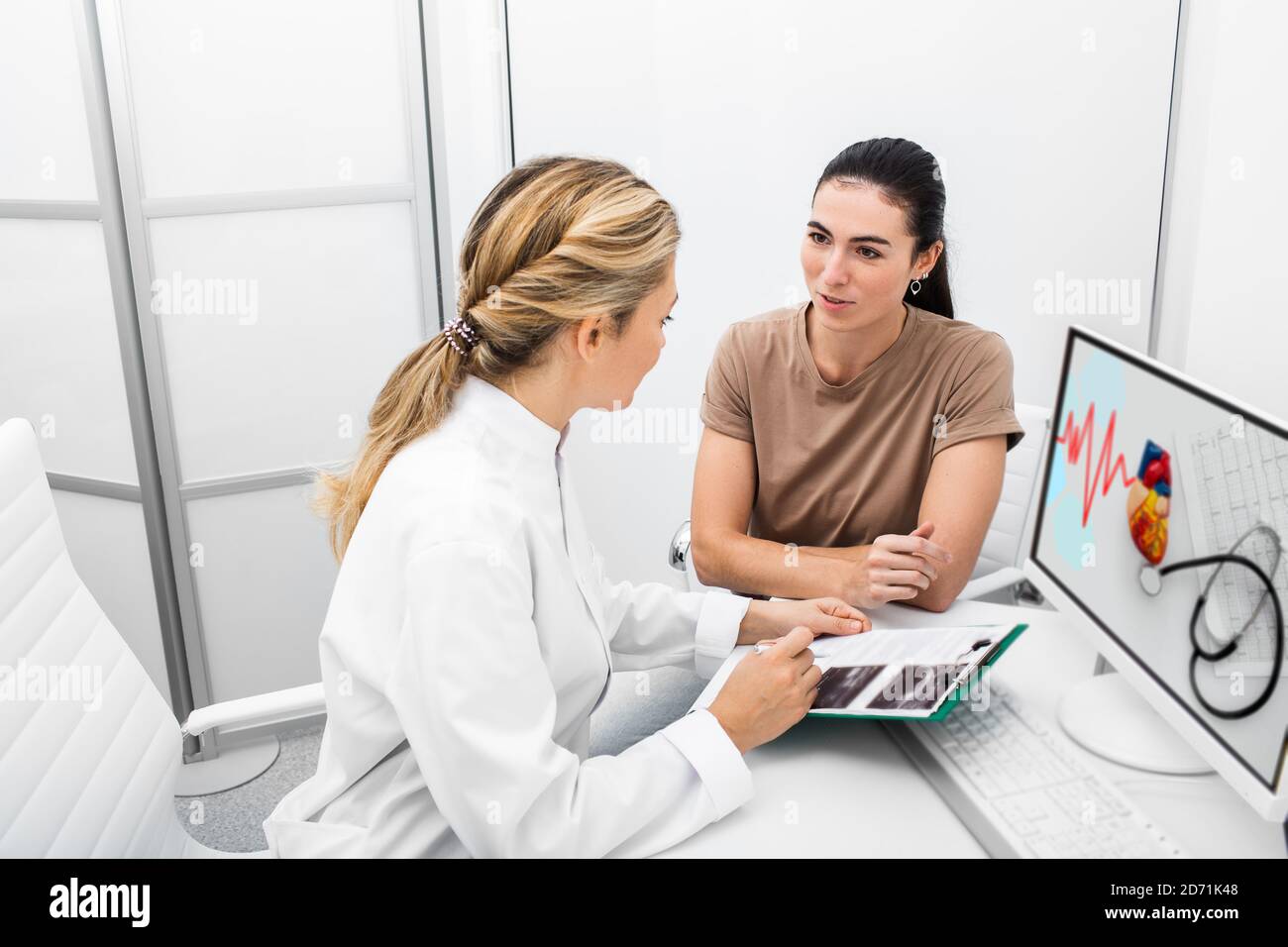 Prevention diagnosis of heart diseases in a woman during a consultation with an experienced cardiologist. Heart attacks and medical treatment Stock Photo