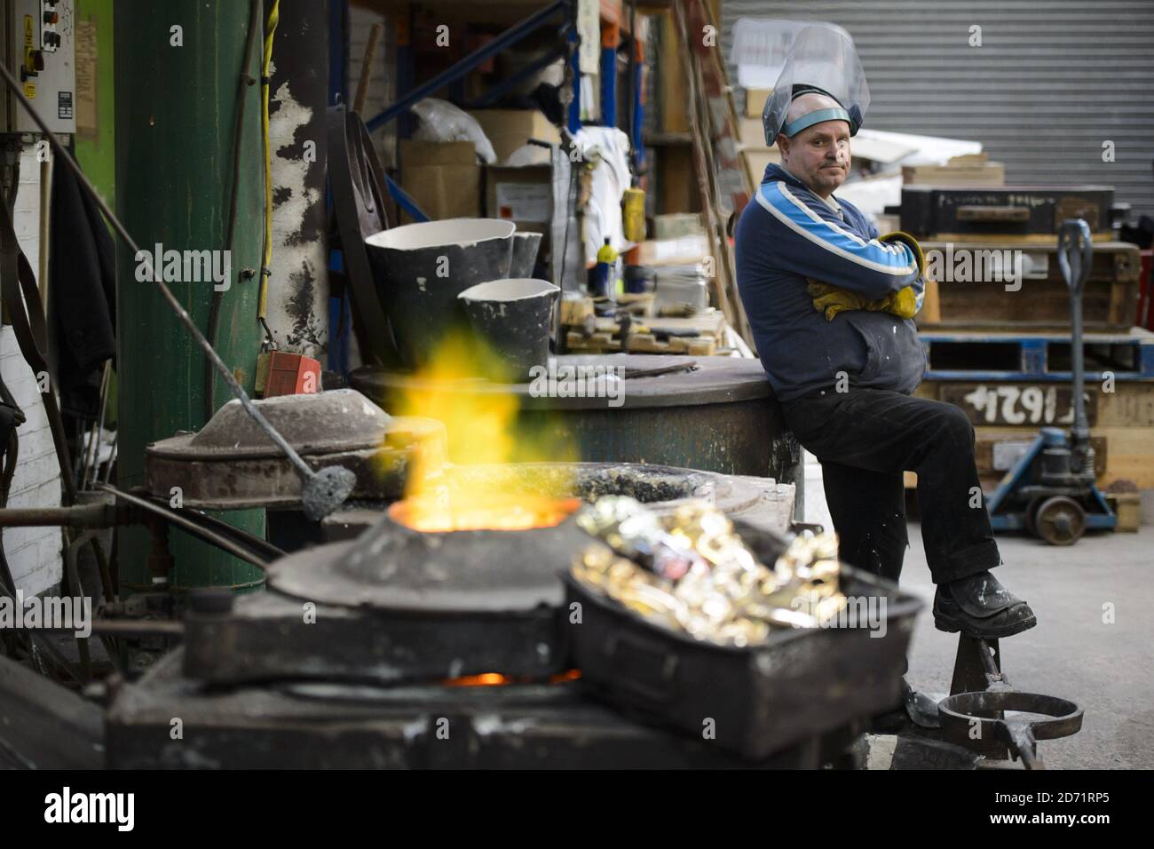 Furnace man Billy Smith heats up bronze for BAFTA masks at a foundry in