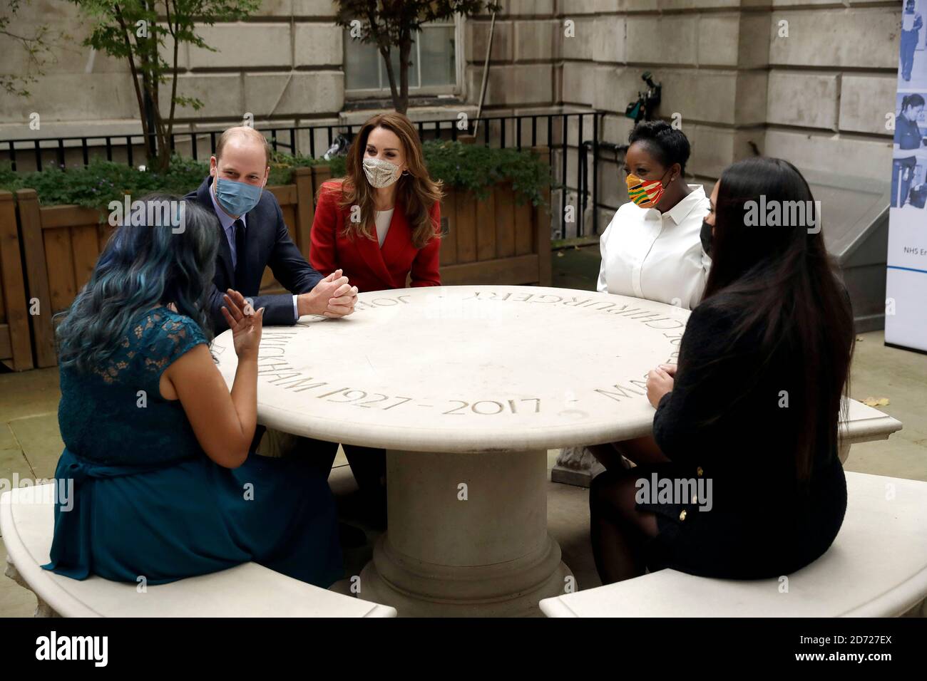 The Duke and Duchess of Cambridge meet pharmacist Joyce Duah (second right), and pharmacy technicians Amelia Chowdhury (right) and Dipal Samuel (left) during a visit to St. Bartholomew's Hospital in London, to mark the launch of the Hold Still photography project. Stock Photo