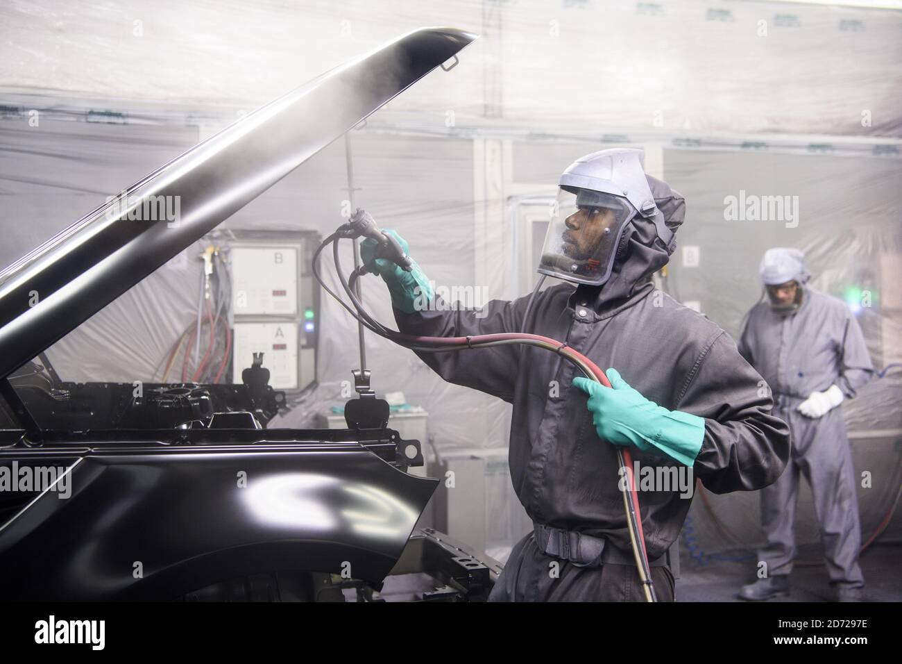 Cars are spray painted in the Paint Shop, part of Jaguar Land Rover's