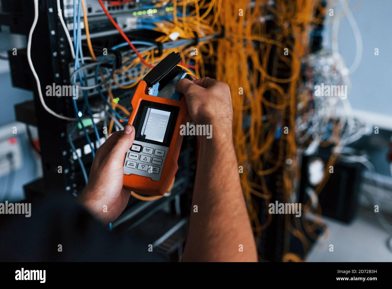 Young man withj measuring device in hands works with internet equipment ...