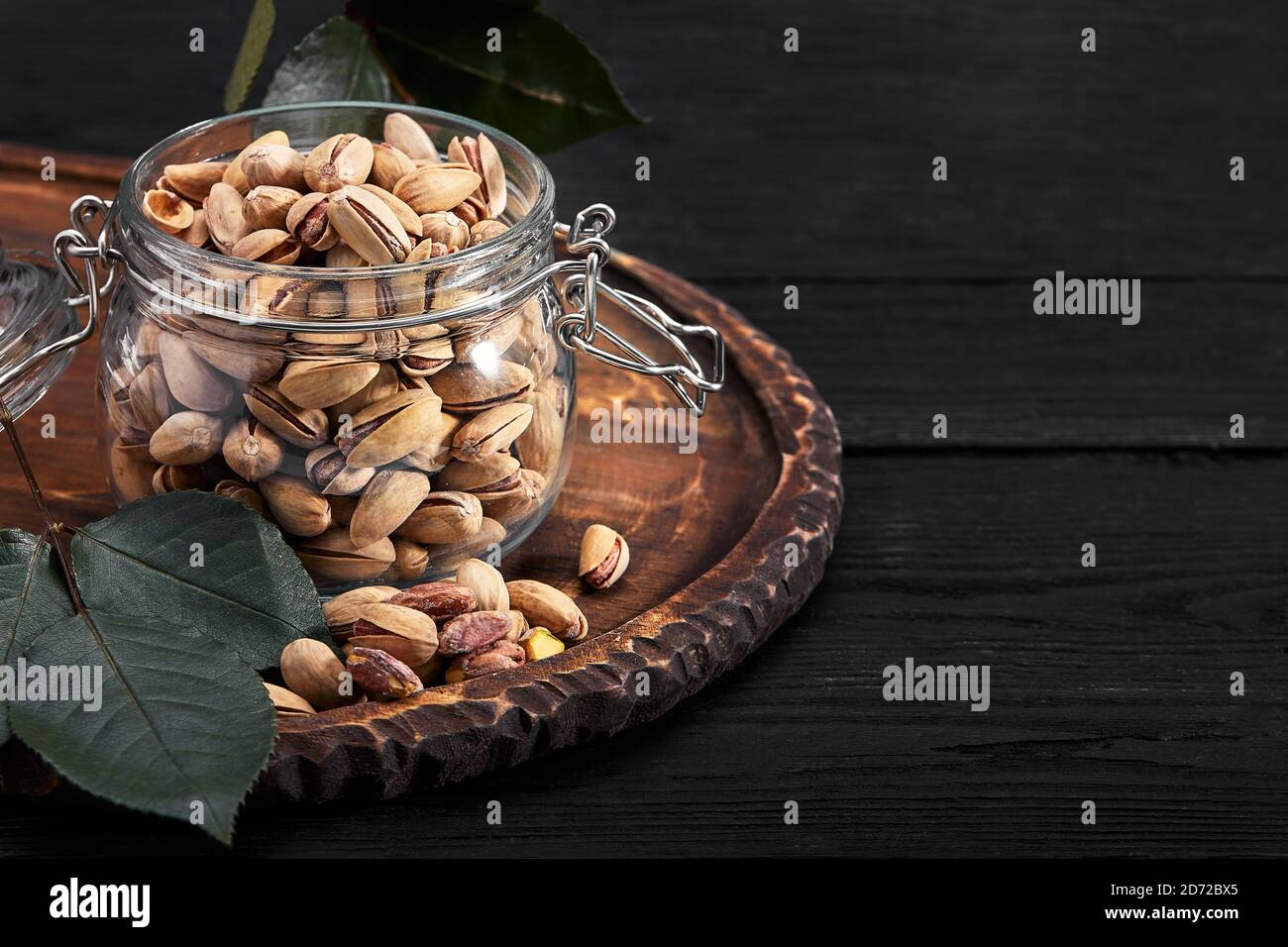 Pistachios nuts on dark background, top view, healthy snack Stock Photo