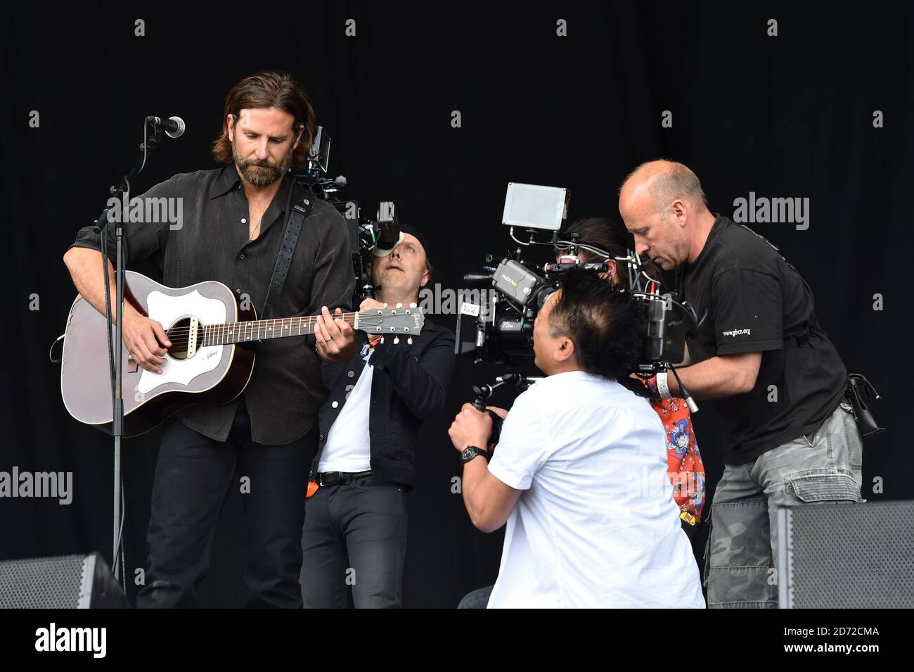 Bradley Cooper films scenes for upcoming film 'A Star Is Born' on the Pyramid Stage, during the Glastonbury Festival at Worthy Farm in Pilton, Somerset. Picture date: Friday June 23rd, 2017. Photo credit should read: Matt Crossick/ EMPICS Entertainment. Stock Photo