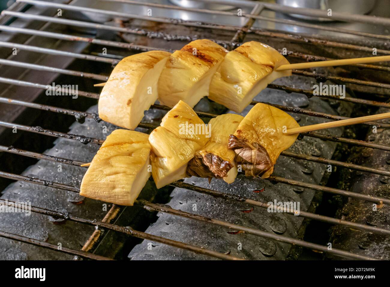 The close up of delicious grilled orinji mushroom at food street night market in Taiwan. Stock Photo