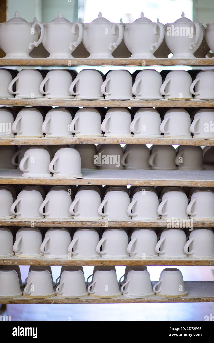 Unfired bone china tableware, or 'biscuit', pictured at Royal Crown Derby's workshop in Derby, England. The company, which dates back to 1750, has just announced its commemorative pieces in honour of the upcoming royal wedding between Prince Harry and Meghan Markle. Royal Crown Derby's bone china is still made entirely in the UK, using techniques largely unchanged since the 18th century. Picture date: Thursday April 19th, 2018. Photo credit should read: Matt Crossick/ EMPICS Entertainment. Stock Photo