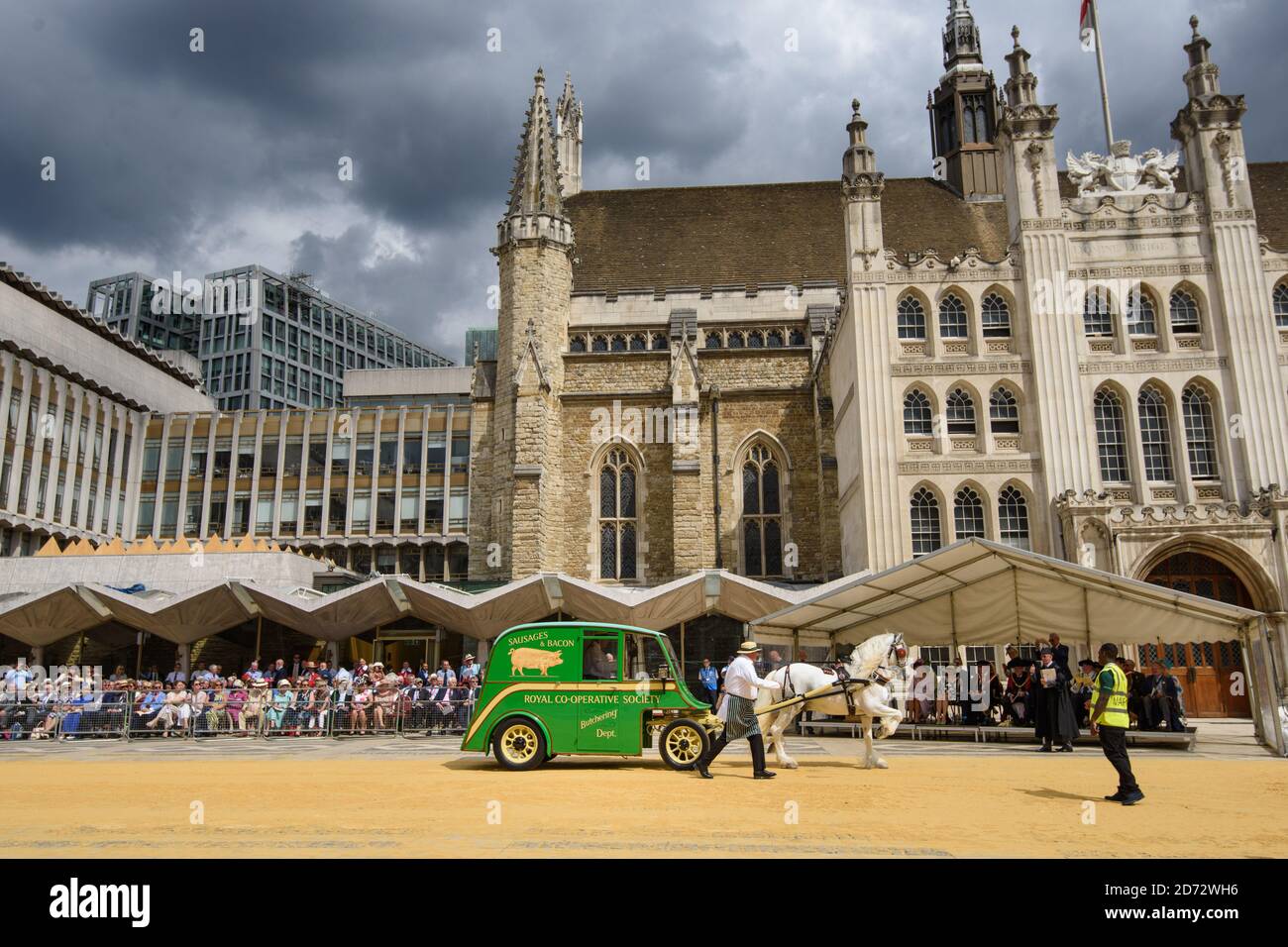 Members of the Worshipful Company of Carmen drive their historic carts and vehicles to Guildhall, in the City of London, for the annual Cart Marking Ceremony. The tradition, originating in the licensing of vehicles for hire in the 17th century, sees each vehicle branded with a letter to mark its official licensed status. Picture date: Wednesday July 18th, 2018. Photo credit should read: Matt Crossick/ EMPICS Entertainment. Stock Photo